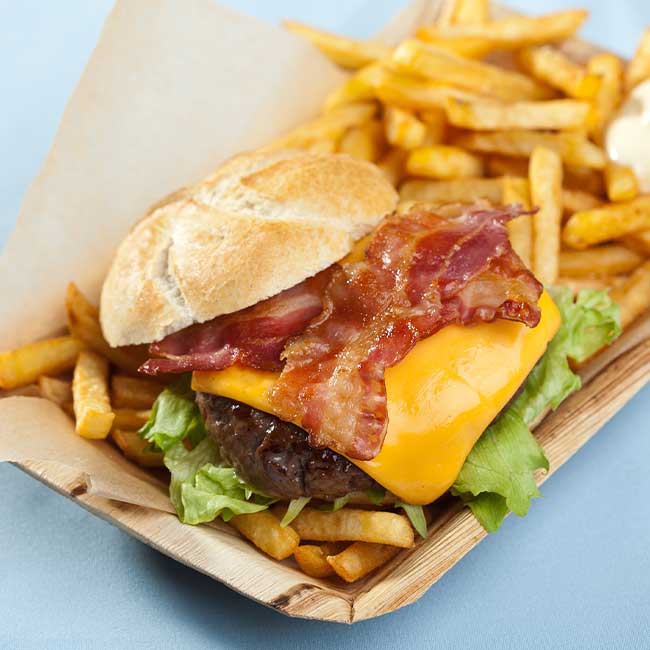 Juicy cheeseburger topped with American cheese and crispy bacon served from the SweetBerry's Family Restaurant lunch and dinner menu with a side of French fries