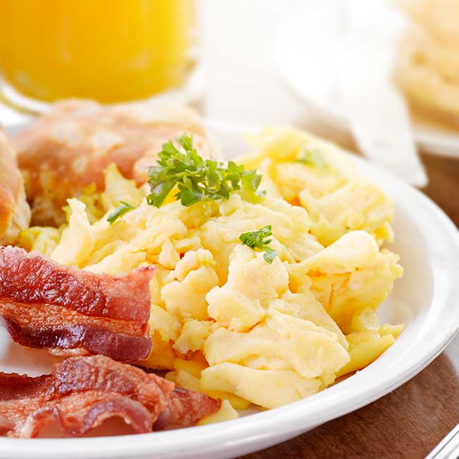 Scrambled eggs, crispy bacon and fresh orange juice served from the SweetBerry's Family Restaurant breakfast menu